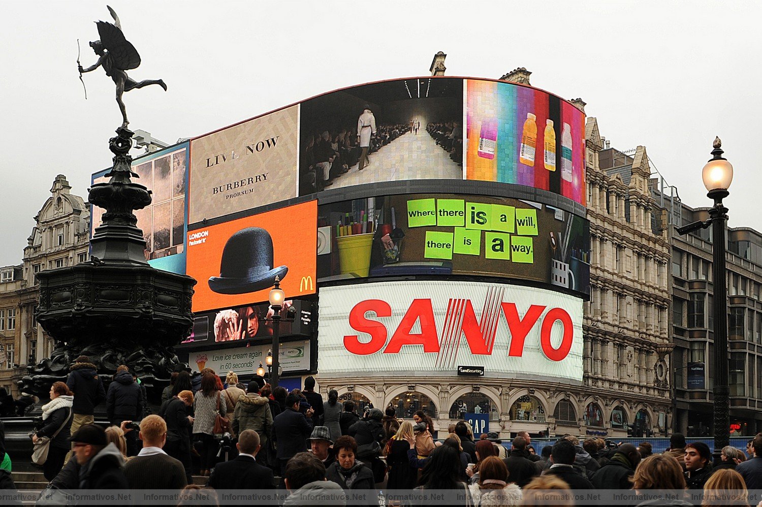 Members of the public watch the Burberry fashion show for the Autumn/Winter 2011 collection as it is screened live on Piccadilly Circus in central London, on the fourth day of the London Fashion Week, on February 21, 2011.