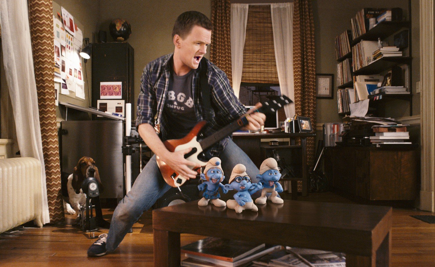 Neil Patrick Harris as " Patrick" with Gutsy, Brainy and Grouchy Smurf playing Rock Band in Columbia Pictures' THE SMURFS.