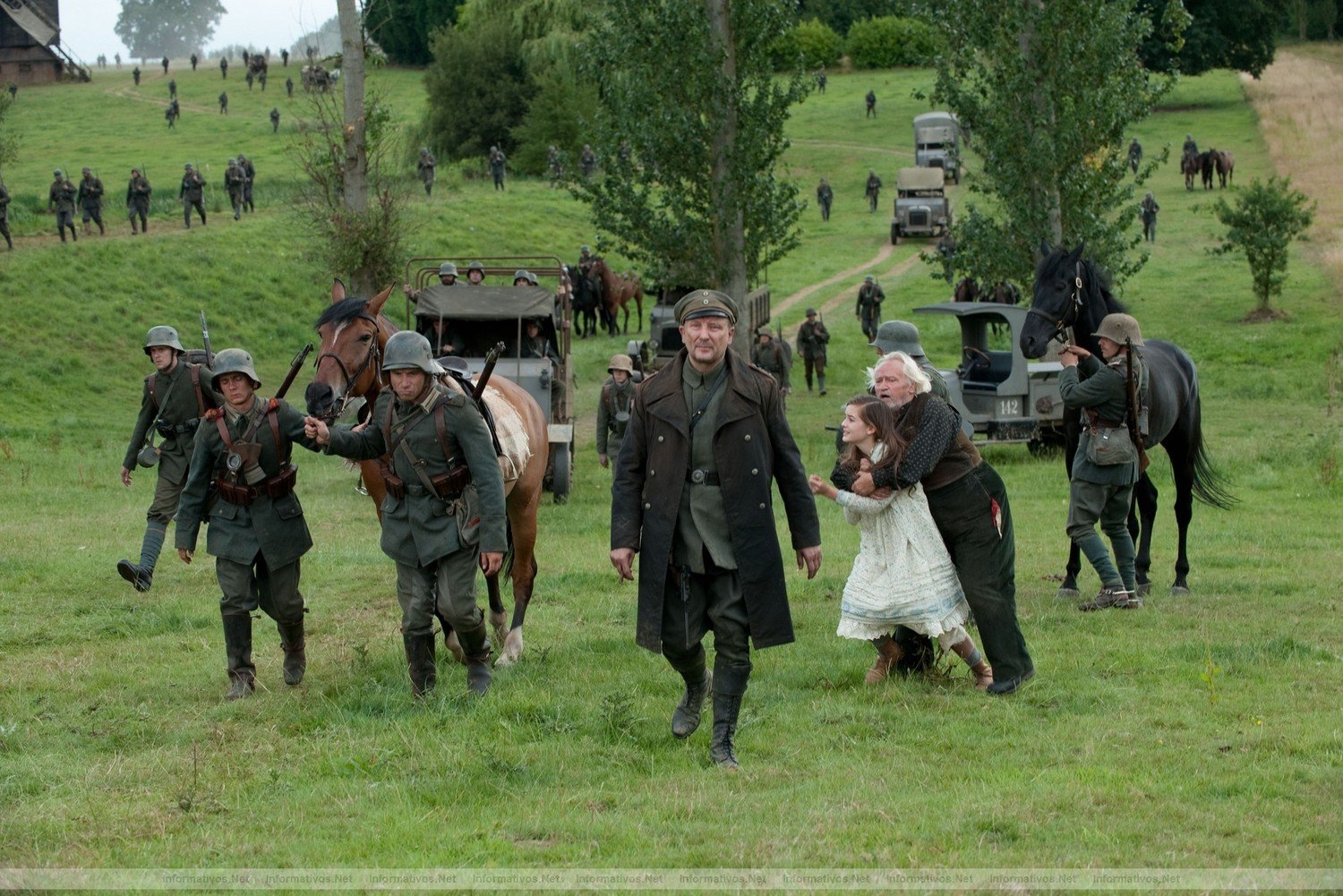 Grief stricken, Emilie (Celine Buckens) is held back by her Grandfather (Niels Arestrup) as the German soldiers, led by Brandt (Rainer Block, center) take away Joey and Topthorn in this scene from DreamWorks Pictures' "War Horse", director Steven Spielberg's epic adventure set against a sweeping canvas of rural England and Europe during the First World War.