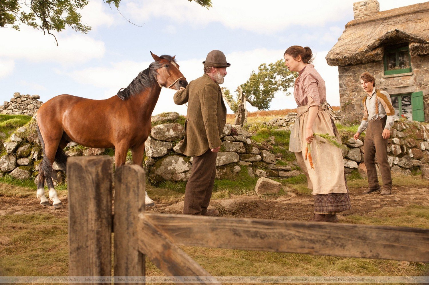 Ted Narracott (Peter Mullan, far left) surprises his wife, Rosie (Emily Watson) and their son, Albert (Jeremy Irvine) with his purchase of a horse in DreamWorks Pictures' "War Horse", director Steven Spielberg's epic adventure and an unforgettable odyssey through courage, friendship, discovery and wonder