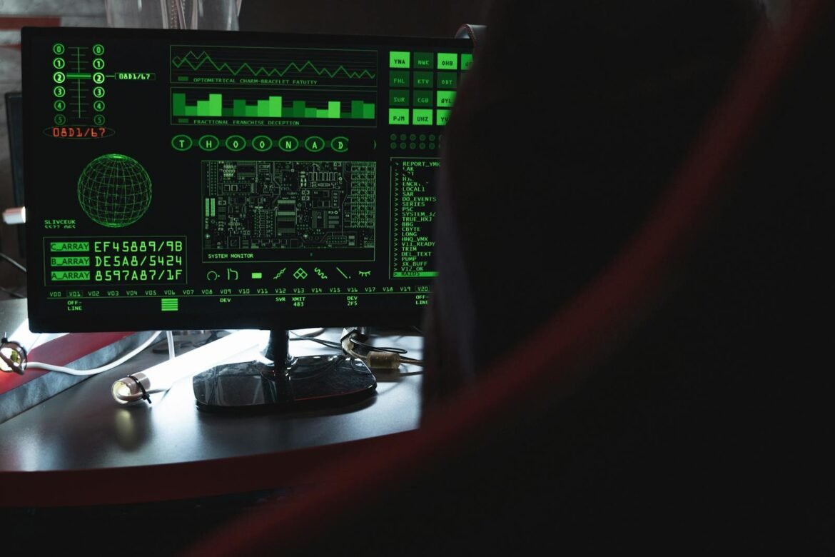 Photo by Tima Miroshnichenko View of a computer monitor displaying green digital security code in an indoor setting.