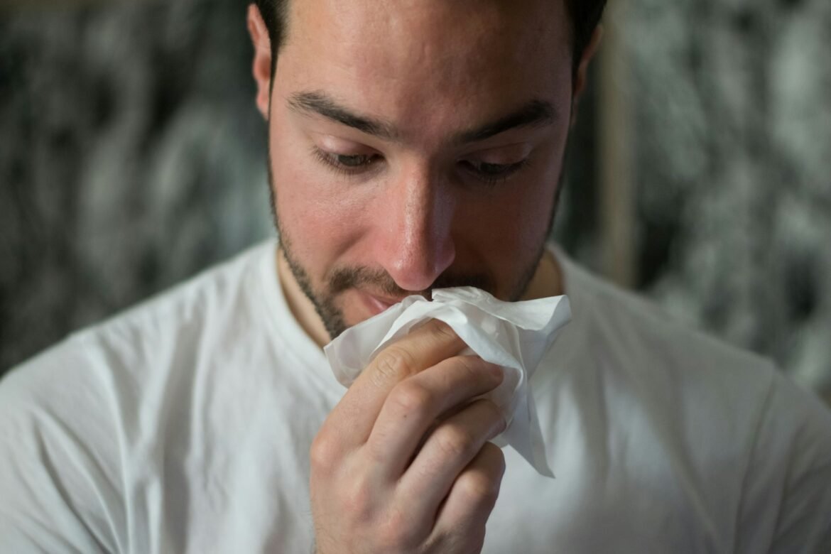 Photo by Brittany Colette man wiping mouse with tissue paper