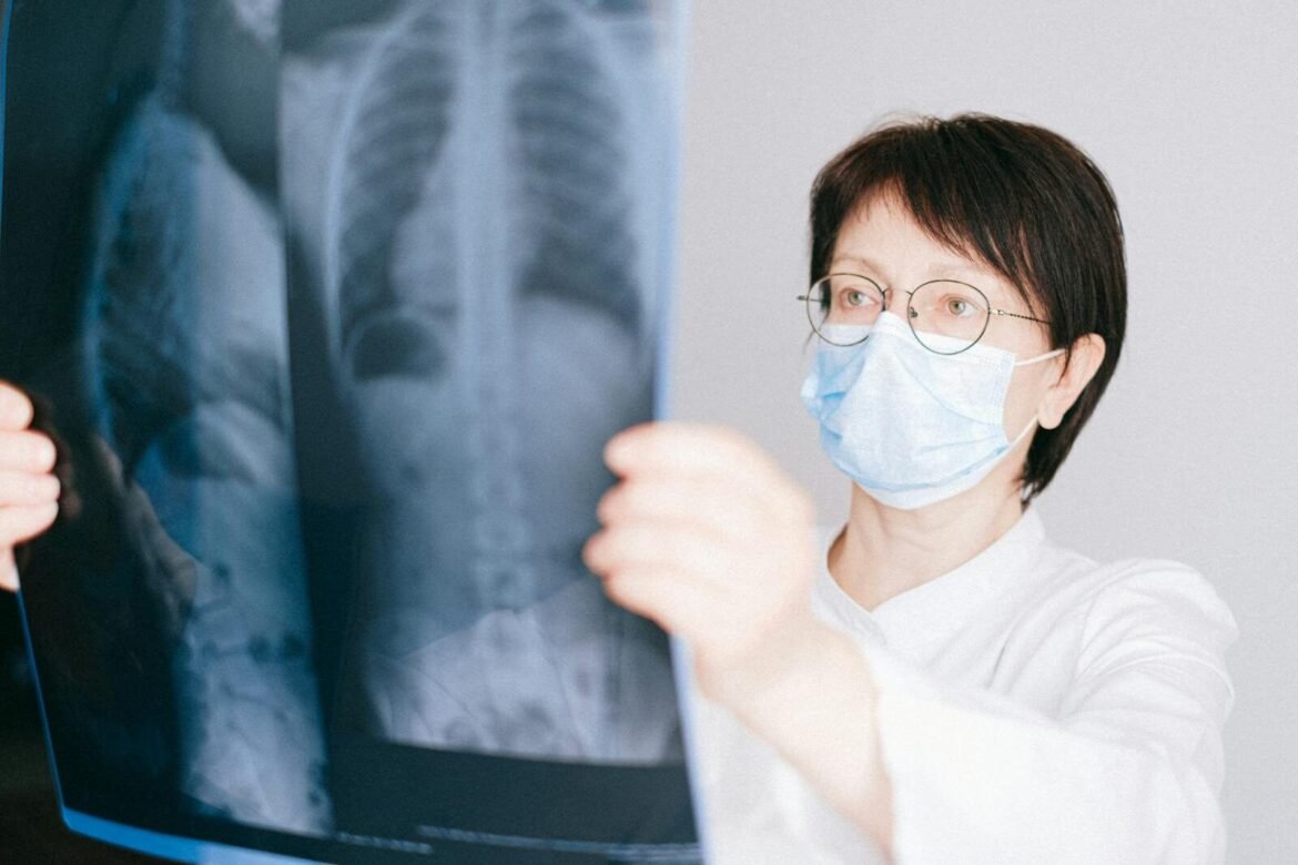 A doctor examines a chest X-ray in a clinical setting, highlighting medical diagnostics.